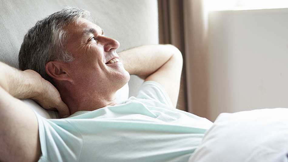 What’s-the-lens-replacement-surgery-recovery-time? "Older man relaxing with hands behind his head"